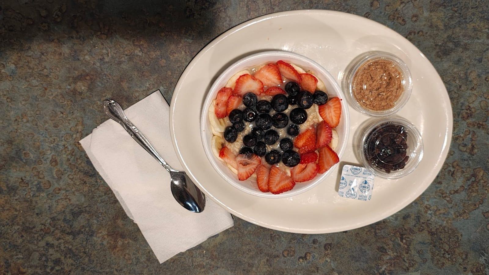 Oatmeal bowl topped with fresh strawberries, blueberries and banana at Ranch House Makarios in Vestavia Hills, AL