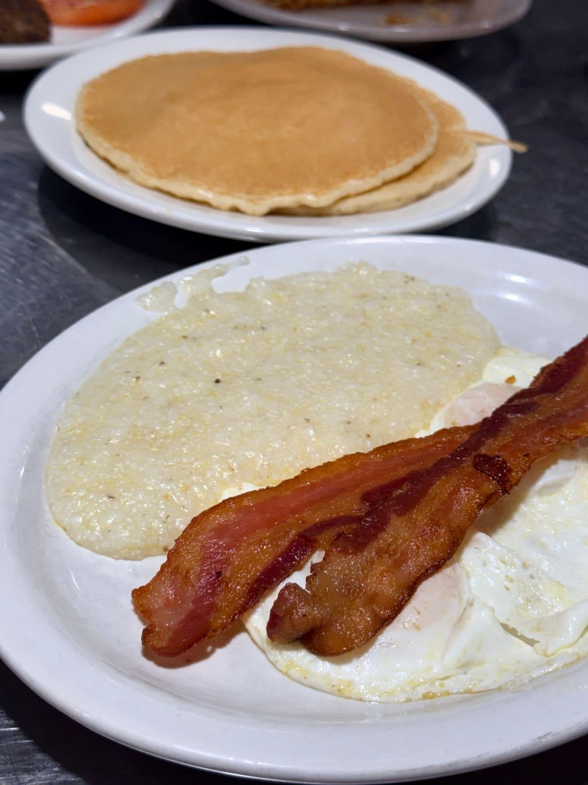 Most Requested breakfast plate with eggs, bacon, grits and pancakes at Ranch House Makarios in Vestavia Hills, AL