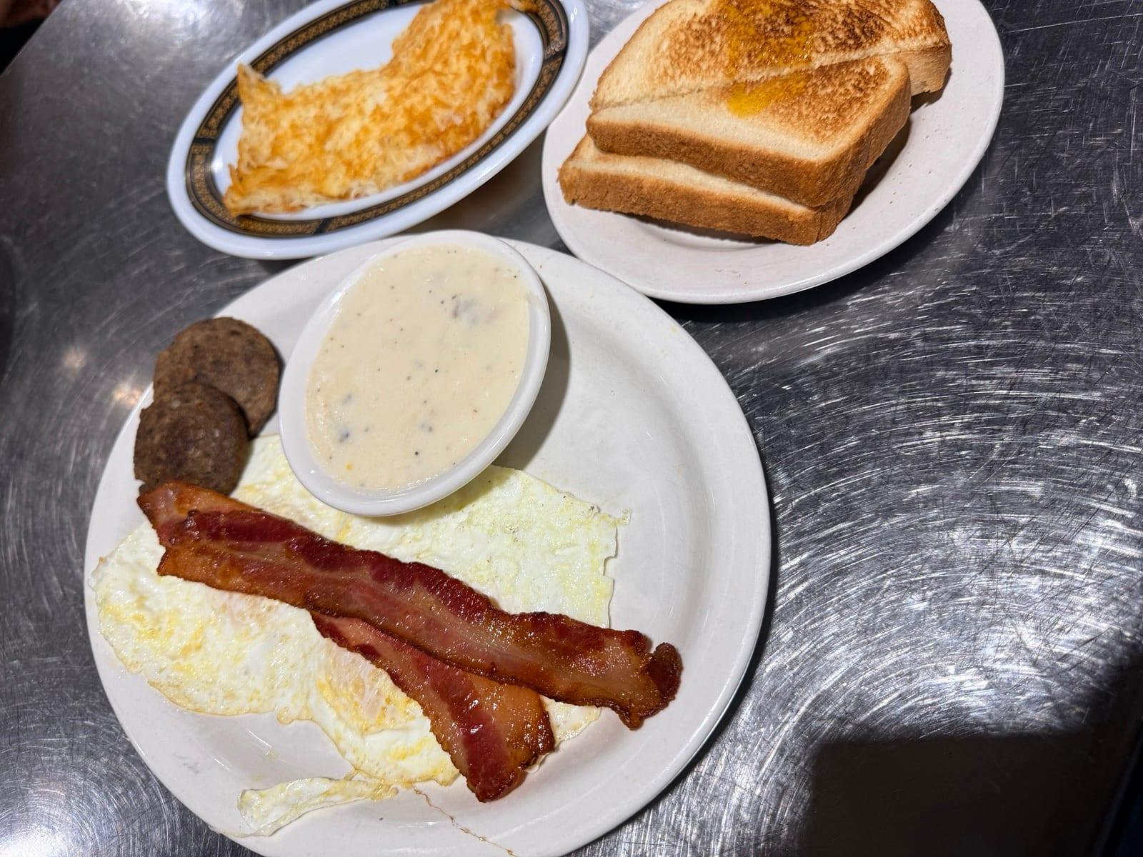 Ranch House Breakfast plate with eggs, bacon, sausage, hash browns, toast and gravy at Ranch House Makarios in Vestavia Hills, AL