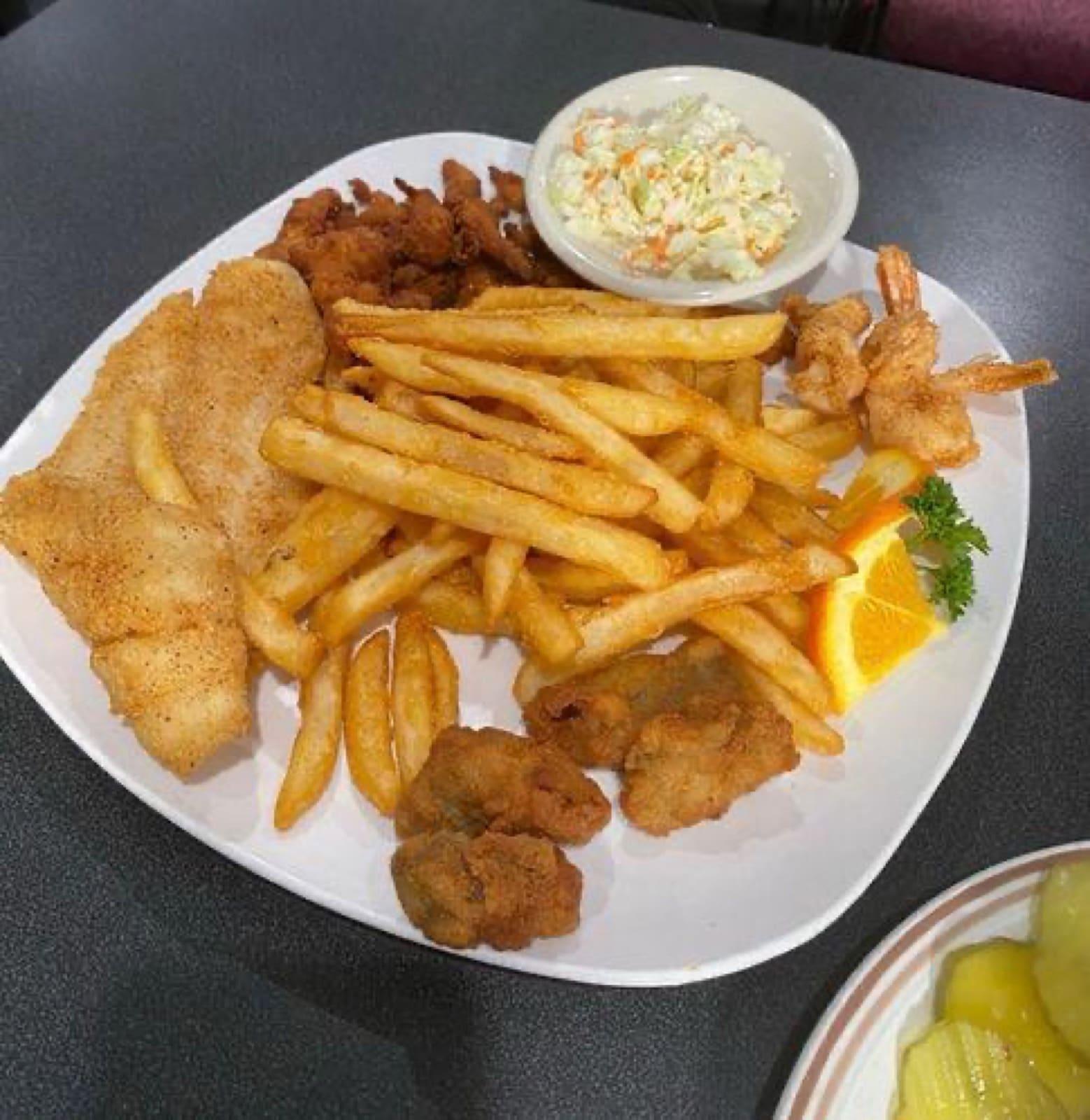Seafood sampler with shrimp, oysters, clam strips, fish and hush puppies at Ranch House Makarios in Vestavia Hills, AL