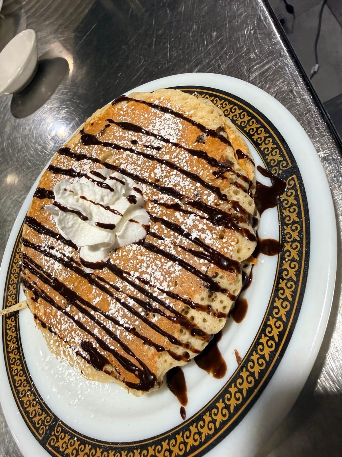 Short stack pancakes with chocolate drizzle and whipped cream at Ranch House Makarios in Vestavia Hills, AL